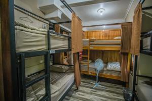 a room with bunk beds on a boat at WW Backpackers in Ubud