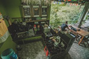 an overhead view of a kitchen with a man sitting at a table at WW Backpackers in Ubud