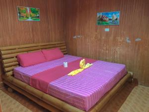 Ένα ή περισσότερα κρεβάτια σε δωμάτιο στο Ging Ging Homes Alona Beach +15 φωτογραφίες