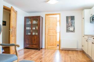 a living room with a door and a wooden floor at Ferienalm Schitter in Mauterndorf