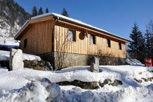 a cabin in the snow with snow around it at Ferienalm Schitter in Mauterndorf
