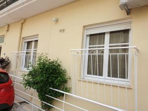 a house with a balcony and a window at Tolis Apartments in Preveza