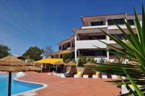 a resort with a swimming pool and a building at Casa Areias Boutique Apartments in Albufeira