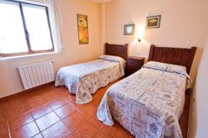 Łóżko lub łóżka w pokoju w obiekcie Vivienda Casa Luisa