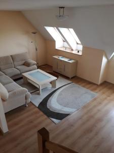 a living room with a couch and a table at Apartamenty Staromłyńska in Szczecin