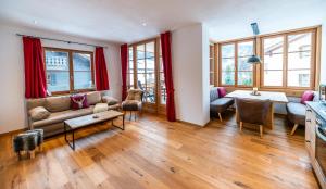 a living room with a couch and a table at Gapartments in Garmisch-Partenkirchen