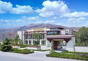 a building with a mountain in the background at Shangri-La Lhasa in Lhasa