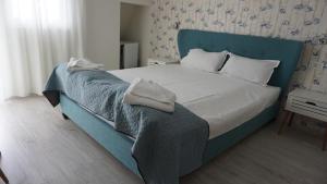 Postel nebo postele na pokoji v ubytování OITUZ Boutique Residence