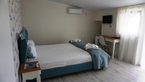 Postel nebo postele na pokoji v ubytování OITUZ Boutique Residence