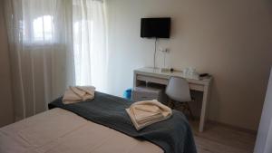 Postel nebo postele na pokoji v ubytování OITUZ Boutique Residence