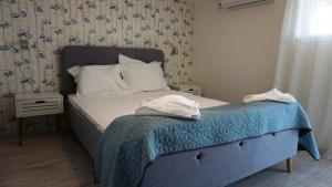 Postel nebo postele na pokoji v ubytování OITUZ Boutique Residence