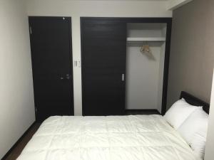 Postel nebo postele na pokoji v ubytování TIMES INN 3F