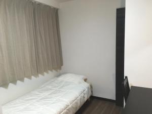 Postel nebo postele na pokoji v ubytování TIMES INN 3F