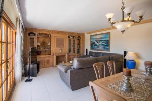 a living room with a couch and a table at Villa Palmera in Ibiza Town