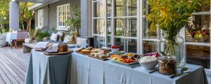 a buffet of food on a table in a house at In Abundance Guest House in Montagu