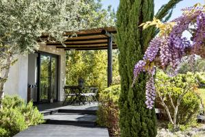 a garden with a pergola and purple flowers at Quinta da Lua in Tavira