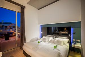 Postel nebo postele na pokoji v ubytování UNA HOTELS One Siracusa