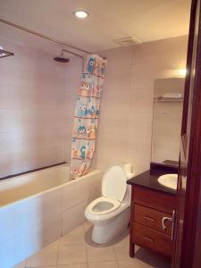 a bathroom with a toilet and a tub and a sink at Beautiful APT in Ha Noi KT in Hanoi