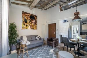 a living room with a couch and a table at Olive Loft in Florence