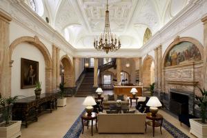 a large lobby with a chandelier and a fireplace at The Landmark London in London