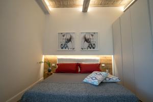 een slaapkamer met een bed met rode kussens bij Olive Loft in Florence