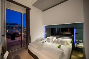 Postel nebo postele na pokoji v ubytování UNA HOTELS One Siracusa