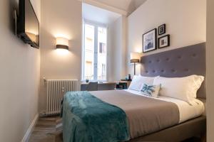 Postel nebo postele na pokoji v ubytování Eccelso Hotel