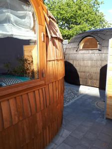 a wooden hut with a window on a patio at Tinyhouse Zollernalb in Balingen