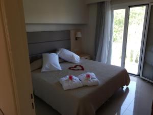 a bedroom with a bed with towels on it at ANGELIKA HOUSE 1 in Marathias