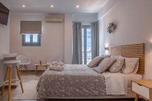 A bed or beds in a room at Andros Blue