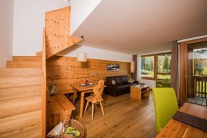 a living room with a table and a couch at Sporthotel Floralpina in Alpe di Siusi