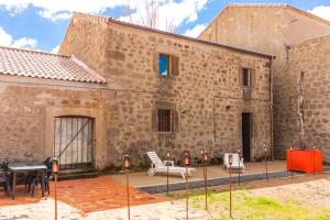 a large brick building with a table and a piano at Casa Rural La Abacería in Mino de Medinaceli +29 photos