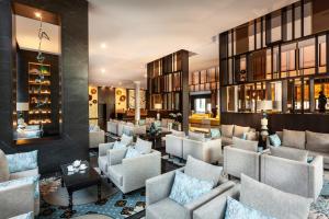 a lobby of a hotel with couches and chairs at Hotel Riu Palace Oasis in Maspalomas