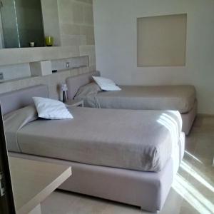 En eller flere senge i et værelse på Masseria Le Fabriche