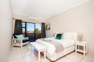 a bedroom with a bed and a large window at King Guest Lodge in Port Elizabeth