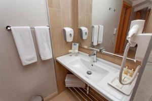 a bathroom with a sink and a mirror at Hotel Aqua in Marmaris