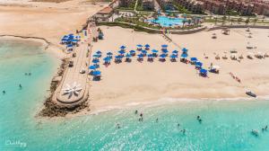 an aerial view of a beach with umbrellas and people at Mirage Hotel Sidi Abd El Rahman in El Alamein