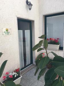 a door to a building with flowers and plants at Residence Ducale in Rodi Garganico