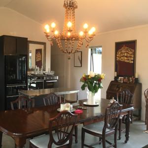 a dining room with a table and a chandelier at Homestead 22 in Cambridge