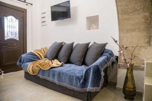 a couch with blue cushions in a living room at Studio Galatia in Kamilari