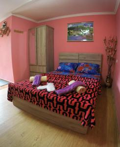 a bedroom with a large bed in a pink room at Galavani in Tbilisi City