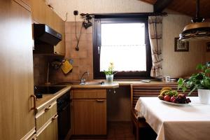 a kitchen with a table with a bowl of fruit on it at Holiday park- Scout in Waldbrunn