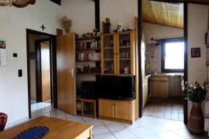 a living room with a tv and a kitchen at Holiday park- Scout in Waldbrunn