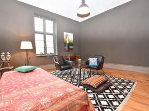 a bedroom with a bed and two chairs and a table at Luxurious Apartment in Steffenshagen with Terrace in Steffenshagen