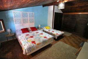 a bedroom with two beds in a room with blue walls at Casa70 in Setúbal