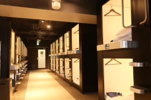 a row of wardrobes in a prison cell at ビジネスカプセルホテル Lightning Hotel浅草 in Tokyo