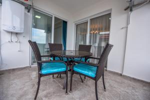 a black table and chairs with blue seats on a balcony at BAHAR RESIDENCE in Trabzon
