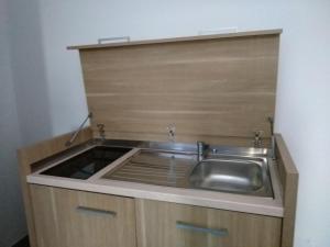 a kitchen with a sink in a wooden cabinet at Agriturismo Fattoria delle Milizie in Scicli +60 photos