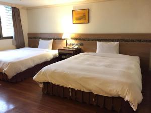 Postel nebo postele na pokoji v ubytování SunWang Hotel