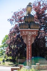 a sign with a bird sitting on top of it at Rowan – Three Tuns Apartments in Pettistree